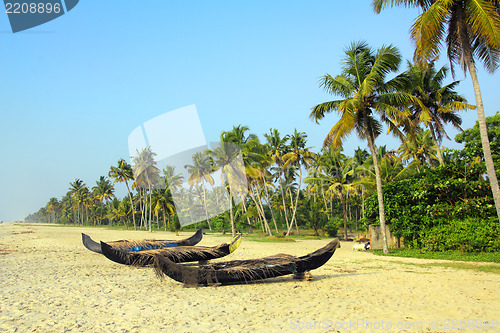 Image of old fishing boats on beach in india