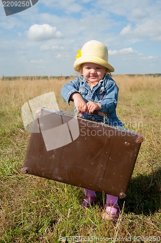 Image of lonely girl with suitcase
