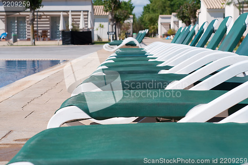 Image of Pool and  chaise longues