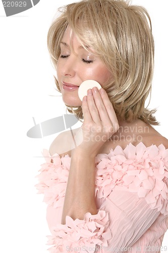 Image of Woman using makeup applicator