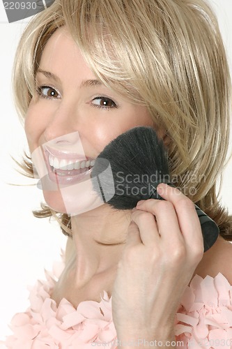 Image of Female holding a large powder brush