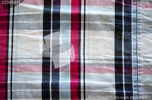 Image of fabric material square red blue black background 