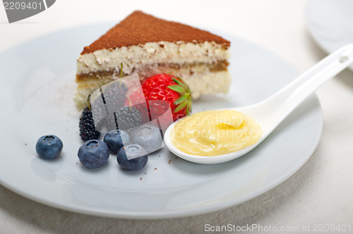 Image of tiramisu dessert with berries and cream