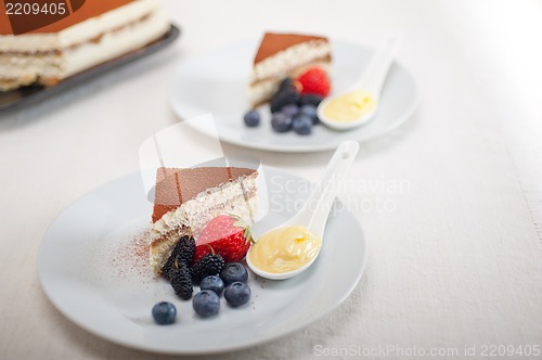 Image of tiramisu dessert with berries and cream