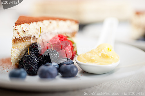 Image of tiramisu dessert with berries and cream