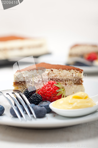 Image of tiramisu dessert with berries and cream