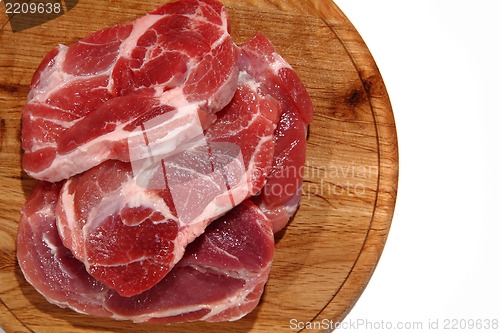 Image of raw meat steak on the wooden board 