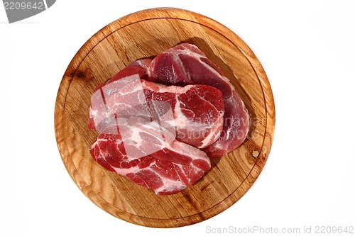 Image of raw meat steak on the wooden board 