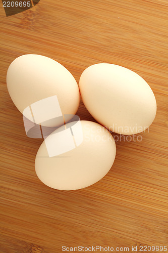Image of Three eggs on wooden background
