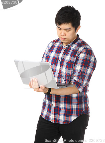 Image of Young asian man using computer