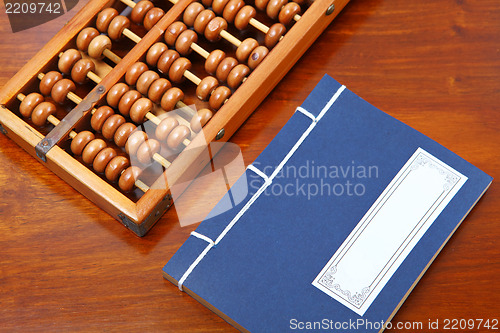 Image of chinese book and abacus
