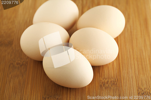 Image of eggs on wooden background