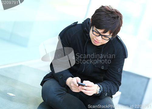 Image of man sms on cell phone