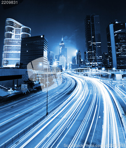 Image of traffic light through city at night