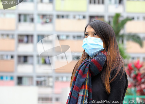 Image of Woman wearing medical face mask in crowded city