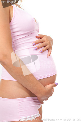 Image of Pregnant woman is caressing her belly