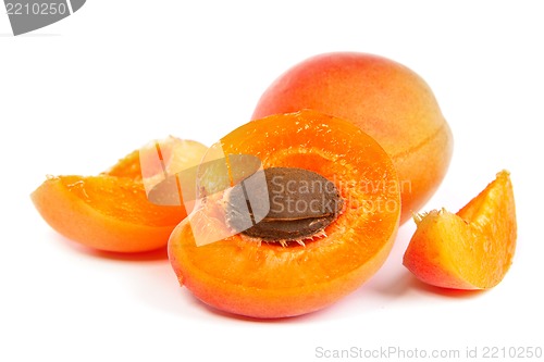 Image of Two ripe apricot sectioned by knife