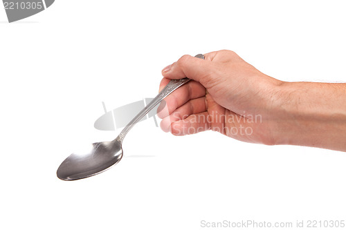 Image of Hand is holding a spoon isolated