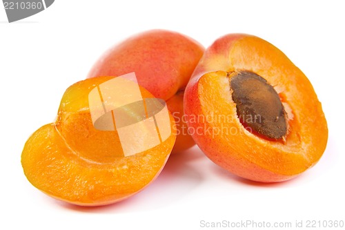 Image of Two ripe apricot sectioned by knife