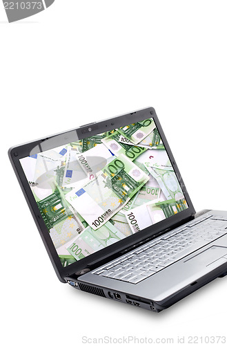 Image of Open laptop with money