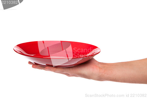 Image of Red kitchen plate on a hand isolated