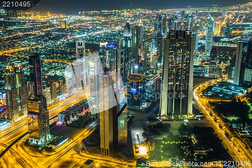 Image of Dubai downtown night scene with city lights,