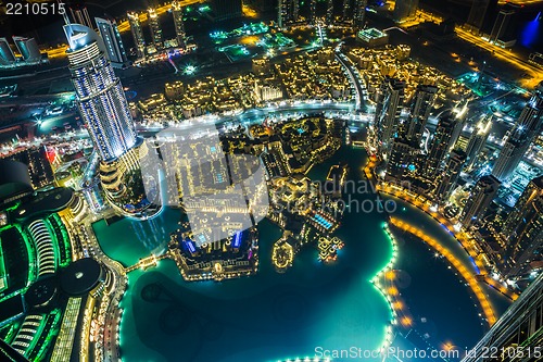 Image of Dubai downtown night scene with city lights,