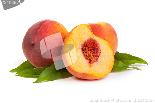 Image of Three tasty juicy peaches with a half  on a white background
