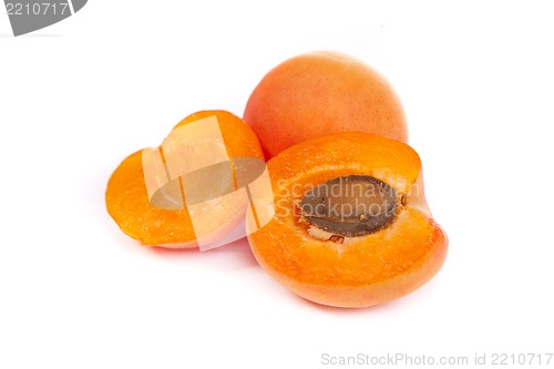 Image of Apricots. Group of ripe apricots with a half sectioned by knife