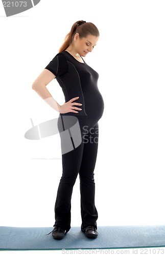 Image of lovely pregnant woman in black working out