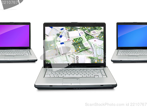 Image of Open laptops with money