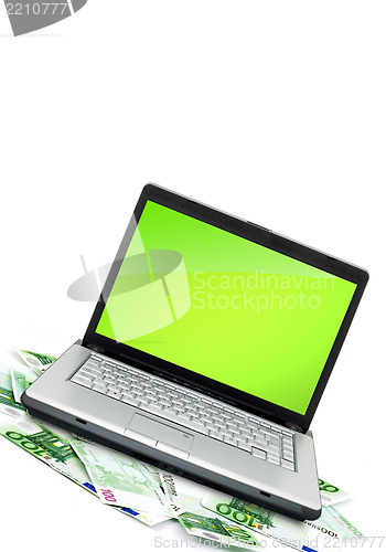 Image of Open laptop with money