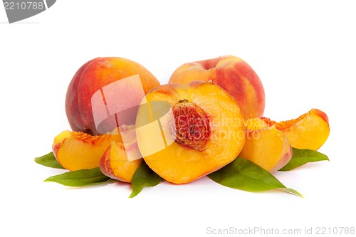 Image of Three tasty juicy peaches with a half and slices  on a white bac