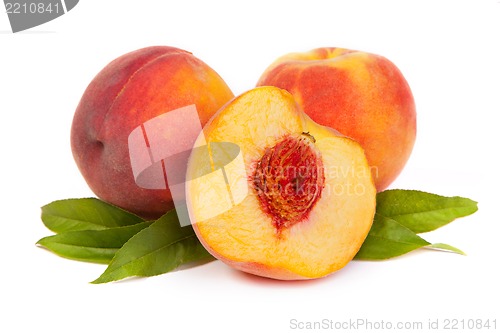 Image of Three tasty juicy peaches with a half  on a white background