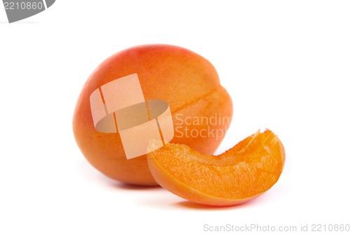 Image of Two ripe apricot sectioned by knife