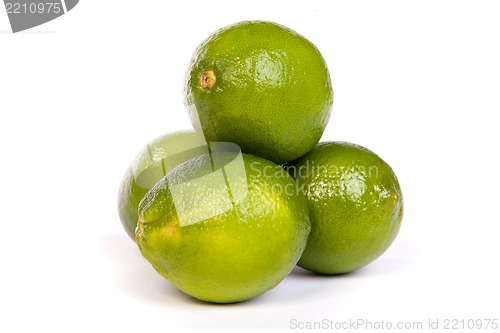 Image of Group of whole limes  and one half lime on white