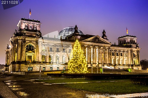 Image of reichstag in berlin in winter at night with christmas tree