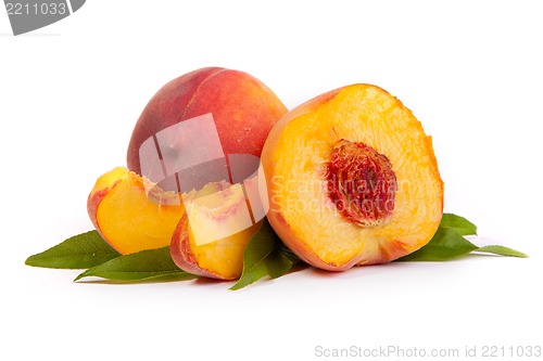 Image of Two tasty juicy peaches with a half and slices  on a white backg