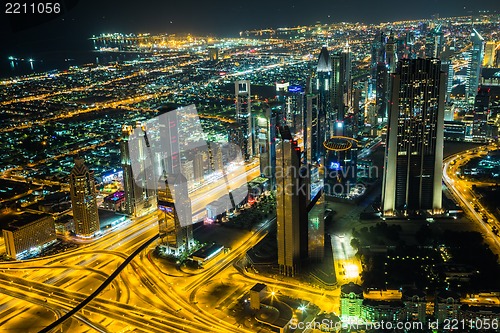 Image of Dubai downtown night scene with city lights,