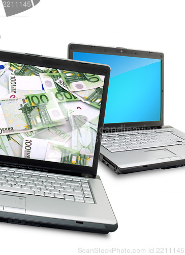 Image of Open laptops with money