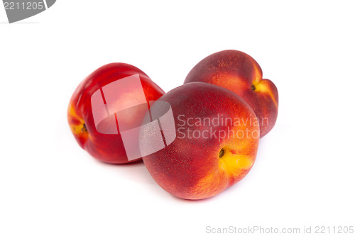 Image of Three fresh nectarines on white