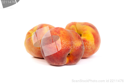 Image of Three tasty juicy peaches on a white background