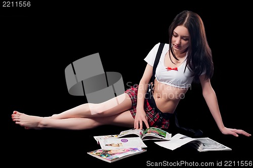 Image of Attractive woman reading magazines