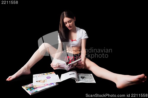 Image of Attractive woman reading magazines
