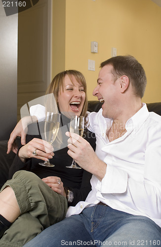 Image of couple sitting on black couch