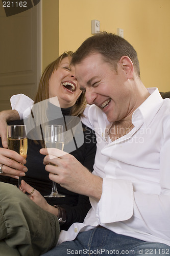 Image of couple sitting on black couch