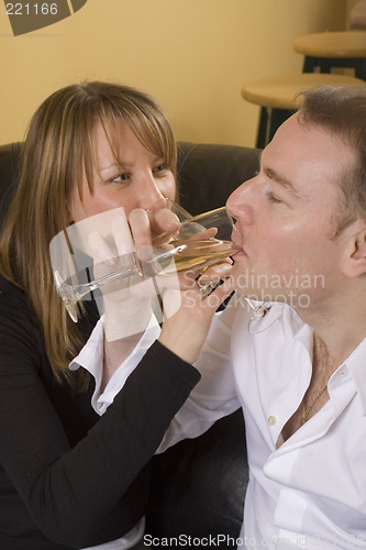 Image of couple sitting on black couch