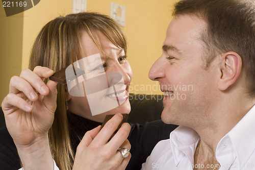 Image of couple on couch eating chocolate