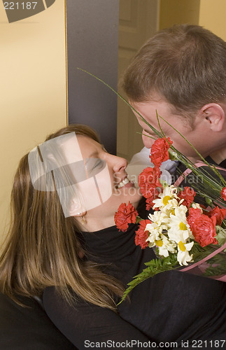 Image of man offering a bouquet to a woman