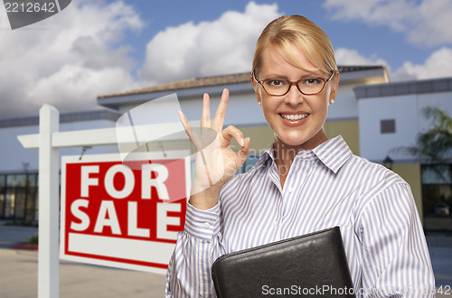 Image of Businesswoman In Front of Office Building and For Sale Sign